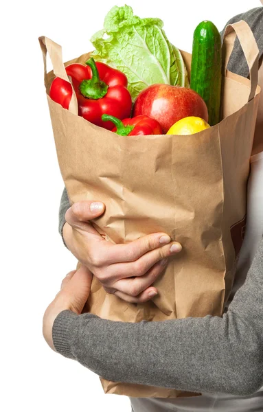 Young woman holding vegetables and fruits in shopping bag — Stock Photo, Image