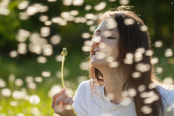 Young woman holding dandelion — Stock Photo, Image