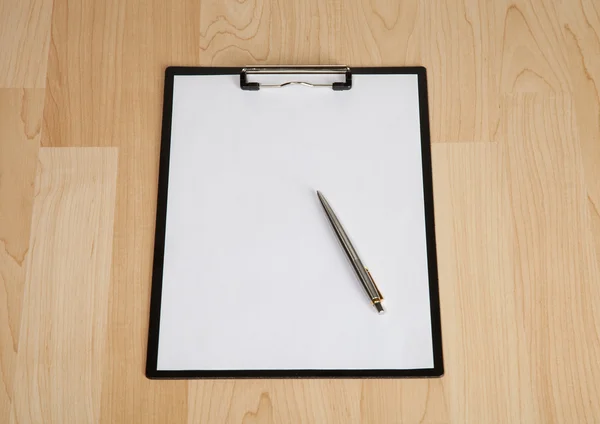 Clipboard and a pen on the table — Stock Photo, Image