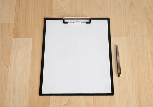 Clipboard and a pen on the table — Stock Photo, Image