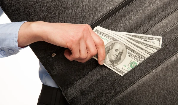 Hand taking money out of briefcase — Stock Photo, Image