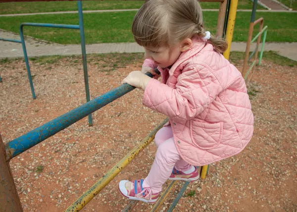 Active little child climbing on a ladder outdoors — Stock Photo, Image