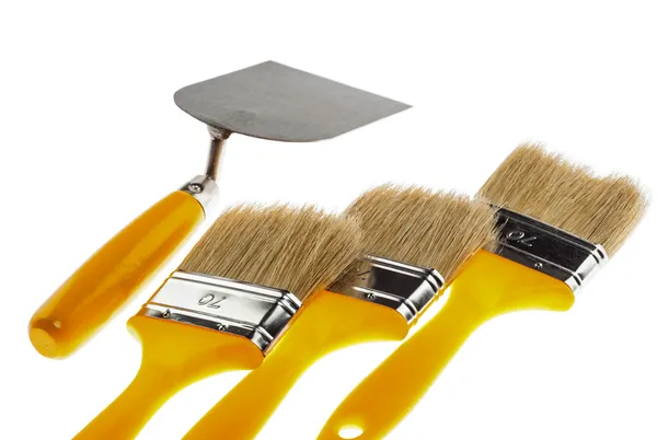 Plastering trowel and paintbrushes — Stock Photo, Image
