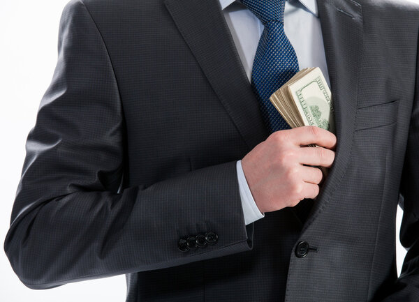 business man putting money in his pocket
