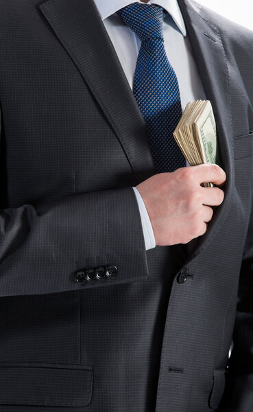 business man putting money in his pocket
