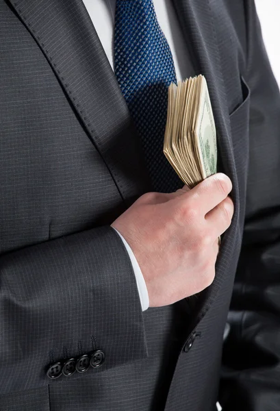 Hombre de negocios poniendo dinero en su bolsillo —  Fotos de Stock