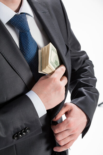 business man putting money in his pocket
