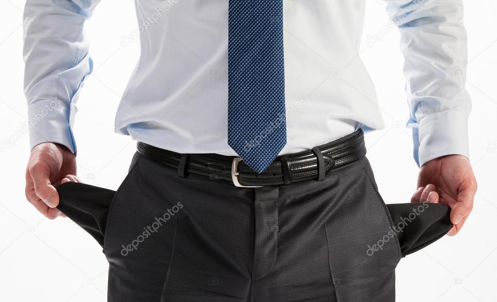 Businessman showing his empty pockets