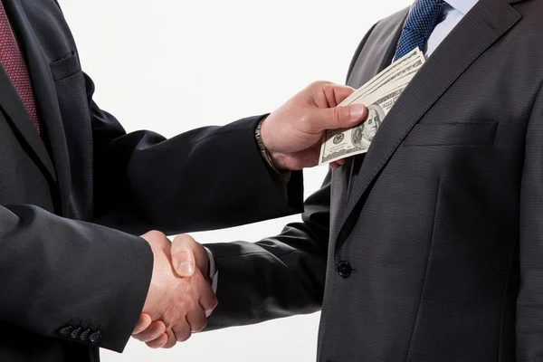 Giving a bribe into a pocket Stock Picture