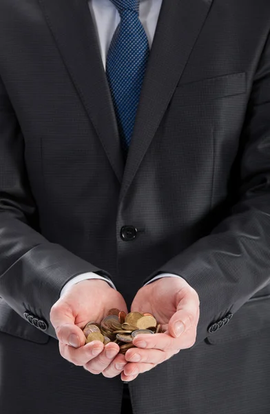 Le mani dell'uomo d'affari che tengono le monete — Foto Stock