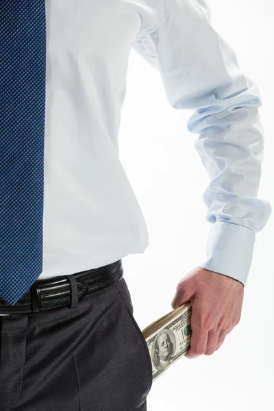 Бизнесмен вытаскивает доллары из кармана — стоковое фото