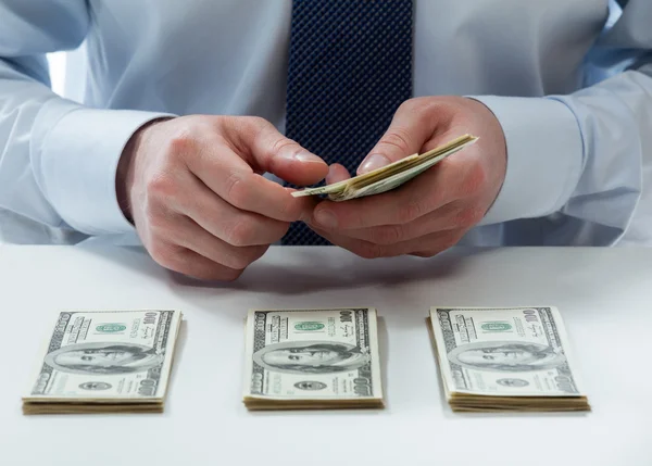 Bank teller counting dollar banknotes — Stock Photo, Image