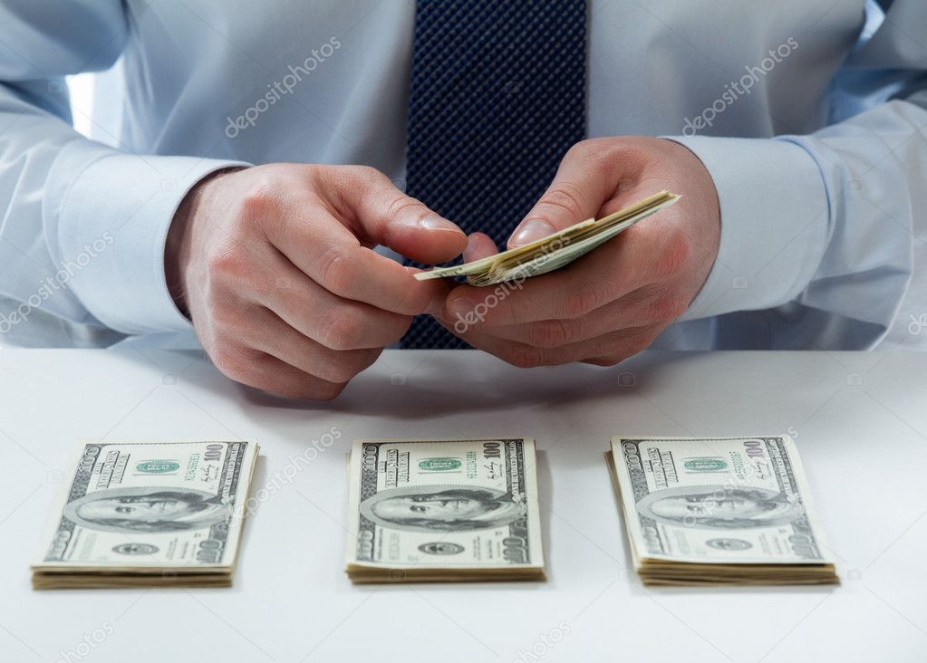 Bank teller counting dollar banknotes