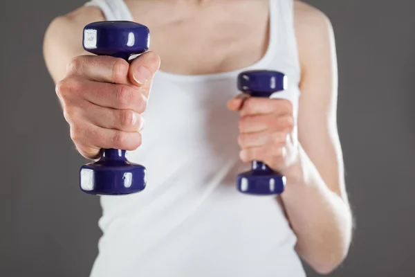 Woman doing exercises with dumbbells — Stock Photo, Image