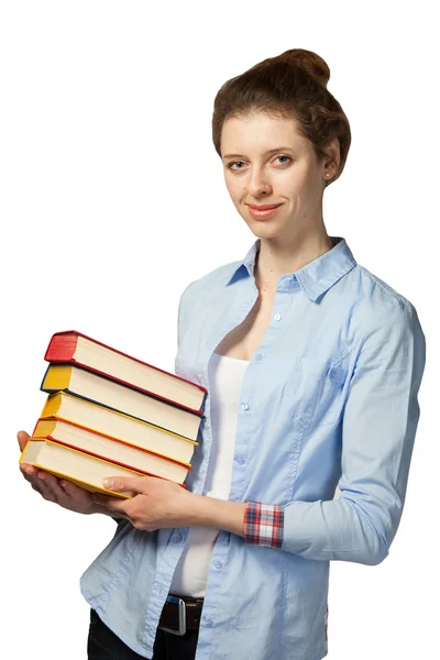 Chica sonriente sosteniendo una pila de libros — Foto de Stock