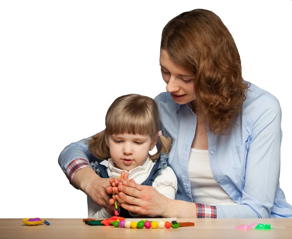 Young mother and her daughter modelling with plasticine — Stock Photo, Image