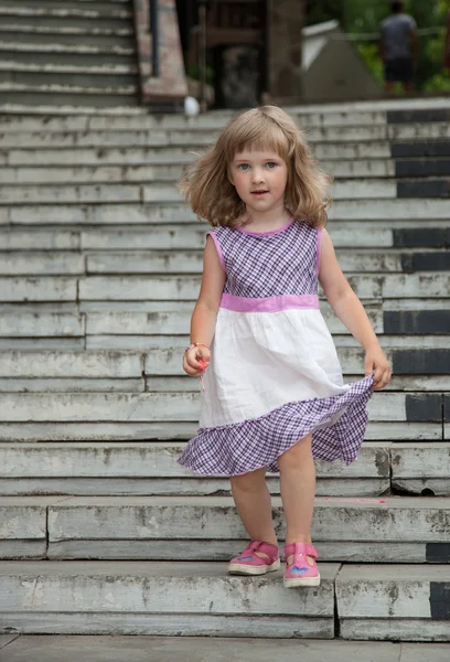 Little girl going down the stone steps — Stock Photo, Image