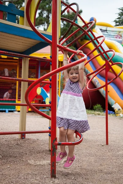 Active little girl playing on a playground — Stock Photo, Image