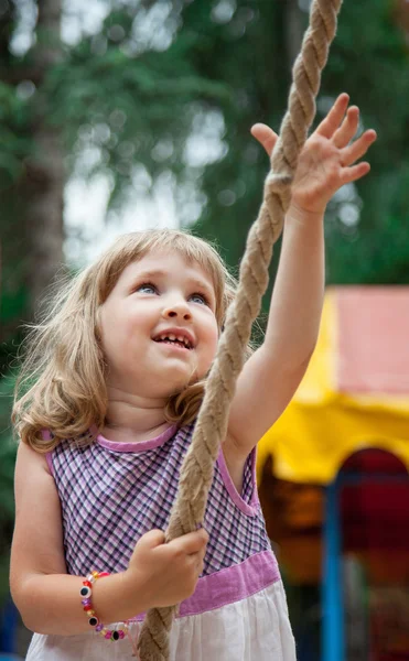 Active little girl playing with rope in a stadium outdoors — Stock Photo, Image