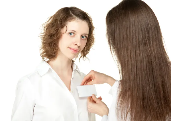 Young women fastening badge at business meeting or conference — Stock Photo, Image