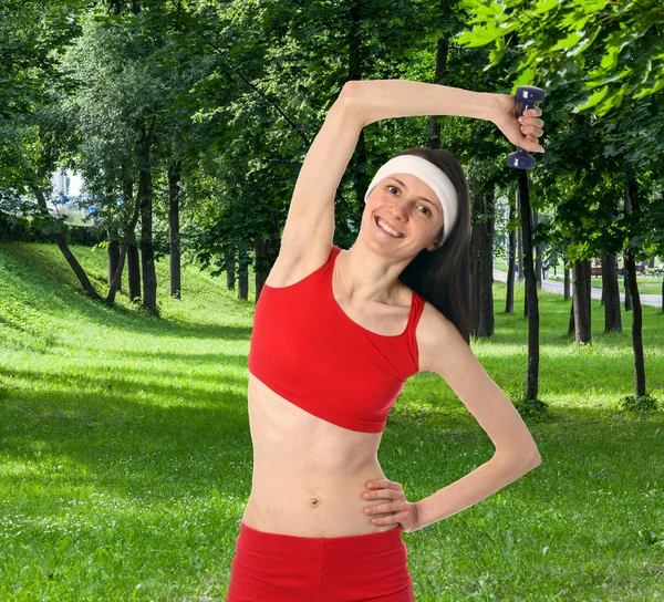 Happy young woman exercising outdoors — Stock Photo, Image