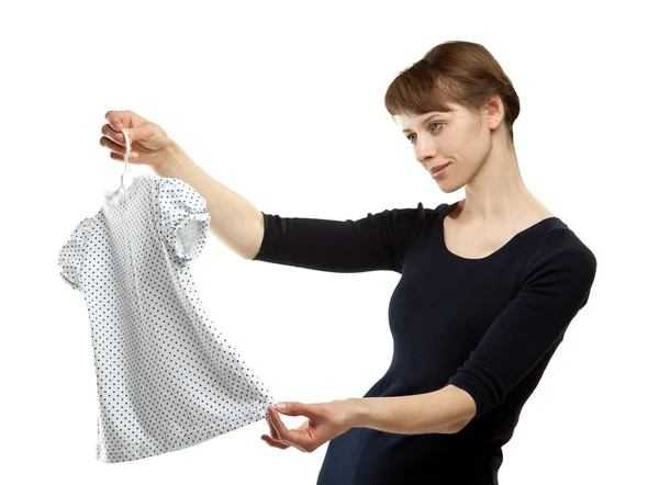 Beautiful young mother choosing dress for daughter — Stock Photo, Image