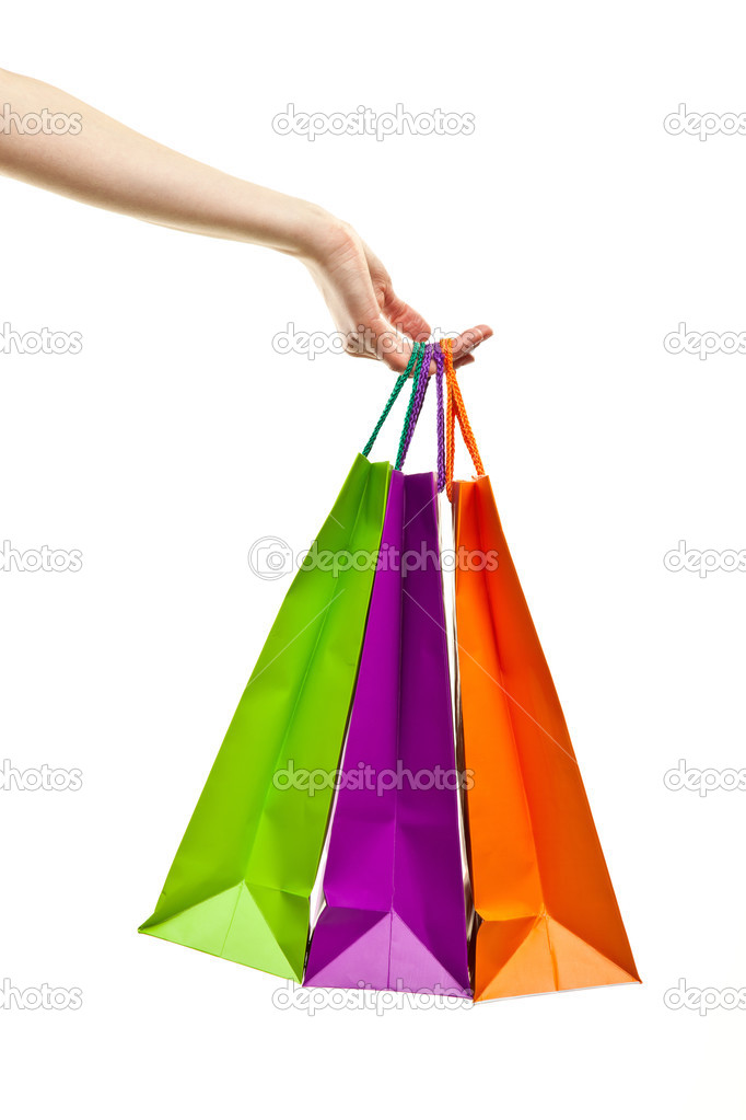 Hand holding multicolored paper bags