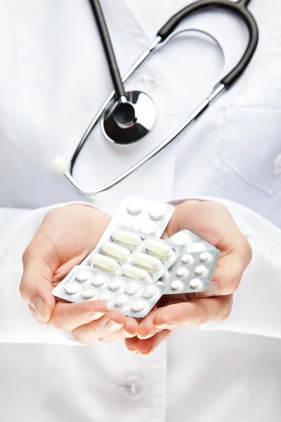 Doctor's hands giving many medicines — Stock Photo, Image