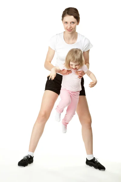 Happy young mother doing sport with little daughter — Stock Photo, Image