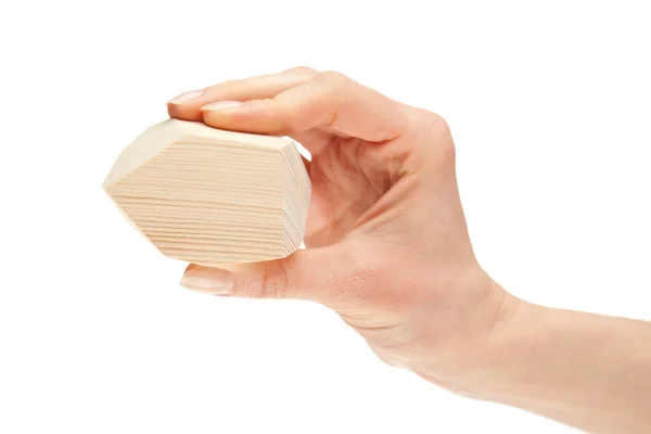 Human hand holding wooden block — Stock Photo, Image