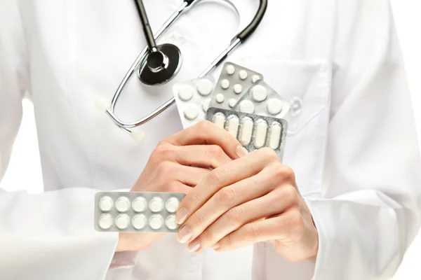 Médico segurando muitos comprimidos — Fotografia de Stock
