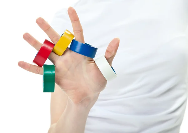 Main humaine avec ruban adhésif multicolore — Photo