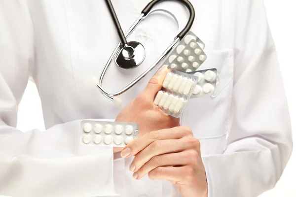 Doctor holding many pills — Stock Photo, Image