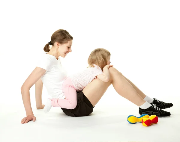 Young woman and her daughter doing sport exercises — Stock Photo, Image