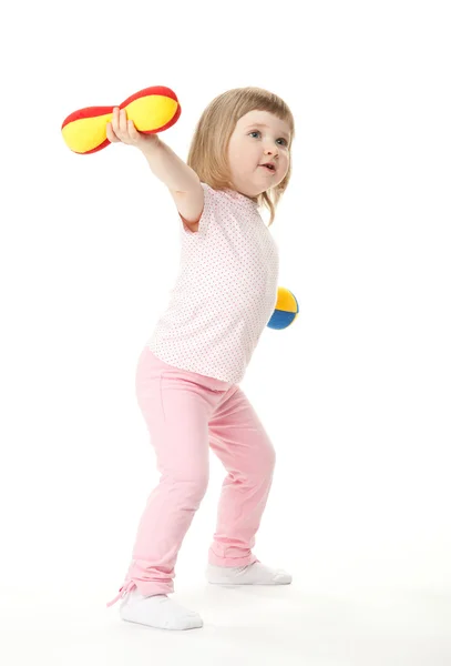 Little baby girl doing sport exercises with toy dumbbells — Stock Photo, Image