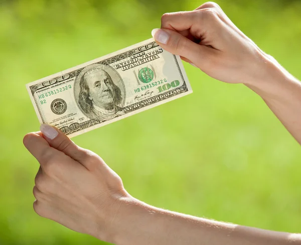 Hands showing dollar banknote — Stok fotoğraf