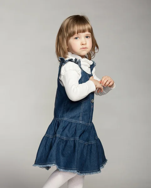 Little girl on dark background — Stock Photo, Image
