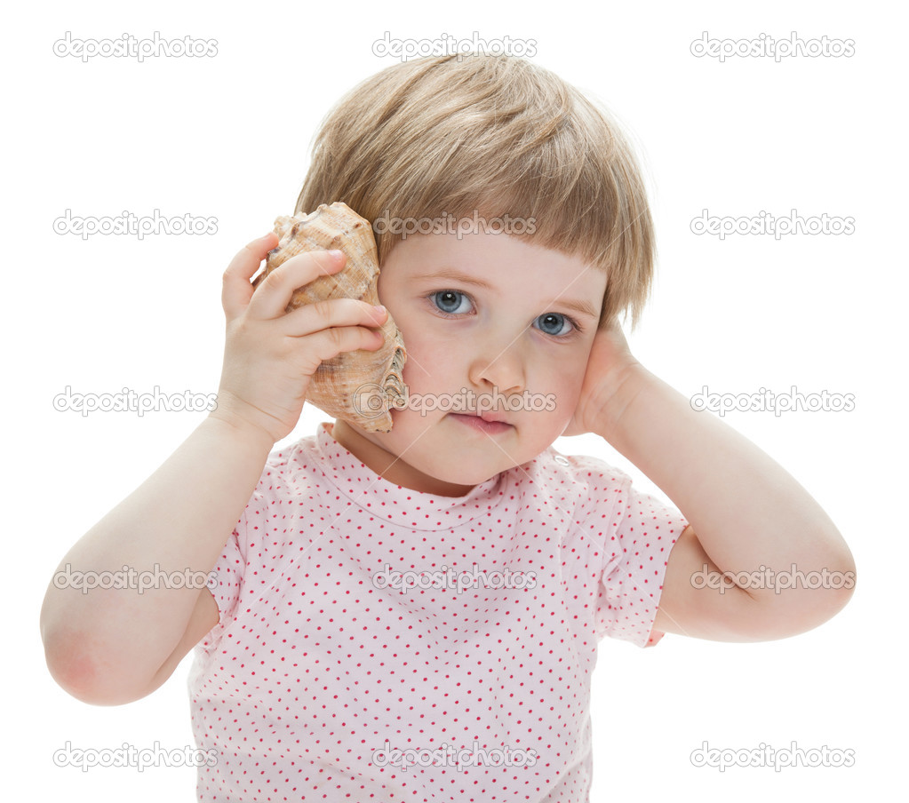 Cute little girl playing with a seashell