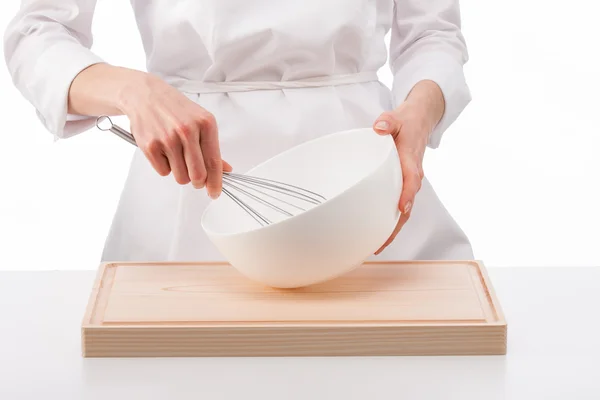 Cook whips something in a white bowl — Stock Photo, Image