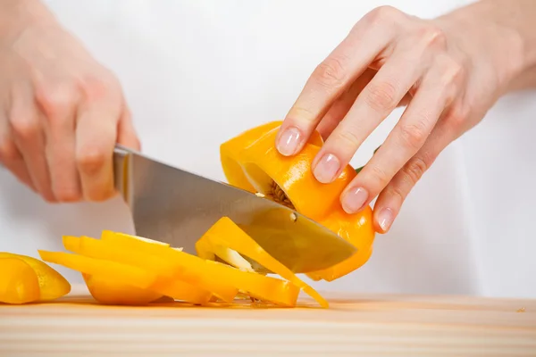 Mains féminines coupant du poivre frais — Photo