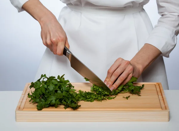 Cook chopping fresh parsley — Stock Photo, Image