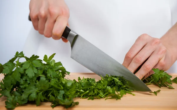 Female hands chopping fresh parsley — Stock Photo, Image