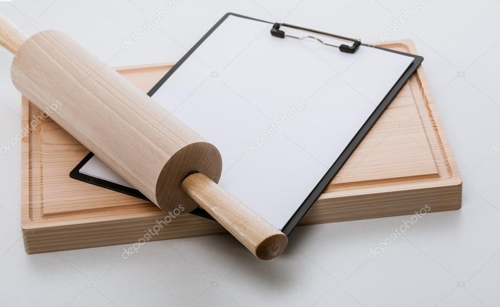 Rolling-pin, and blank clipboard on cutting board