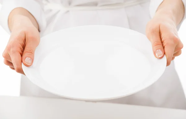 Woman's hands holding white plate — Stock Photo, Image