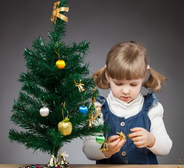küçük kız Noel ağacı süsle