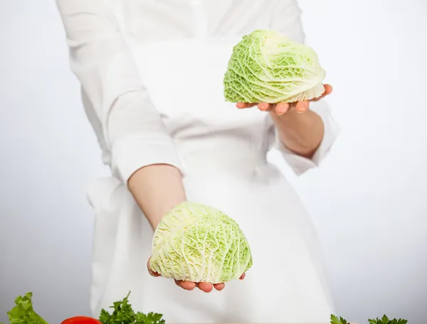 Cook's hands holding savoy cabbage — Stock Photo, Image