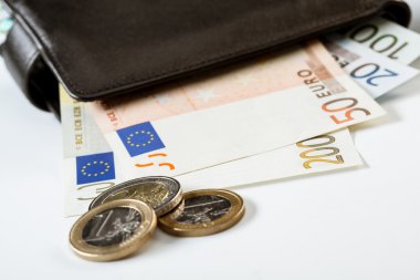 Paper money in leather wallet and coins