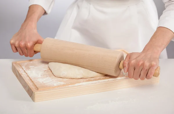 Cook's hands rolling out dough — Stock Photo, Image