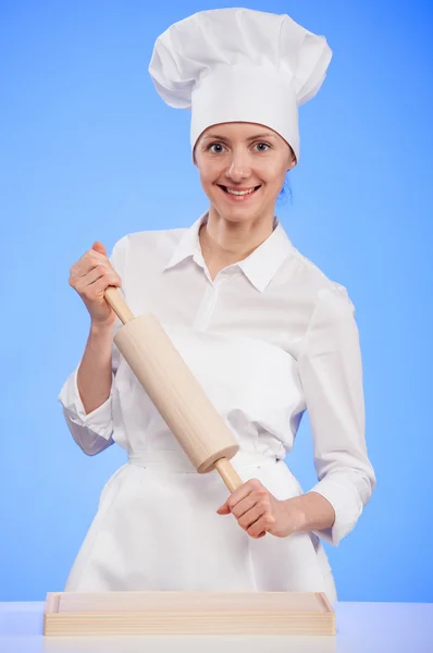 Woman cook holding a rolling pin — Stock Photo, Image