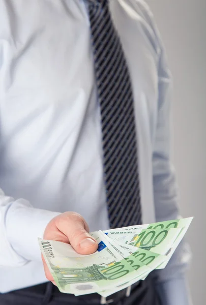 Businessman giving banknotes to you — Stock Photo, Image